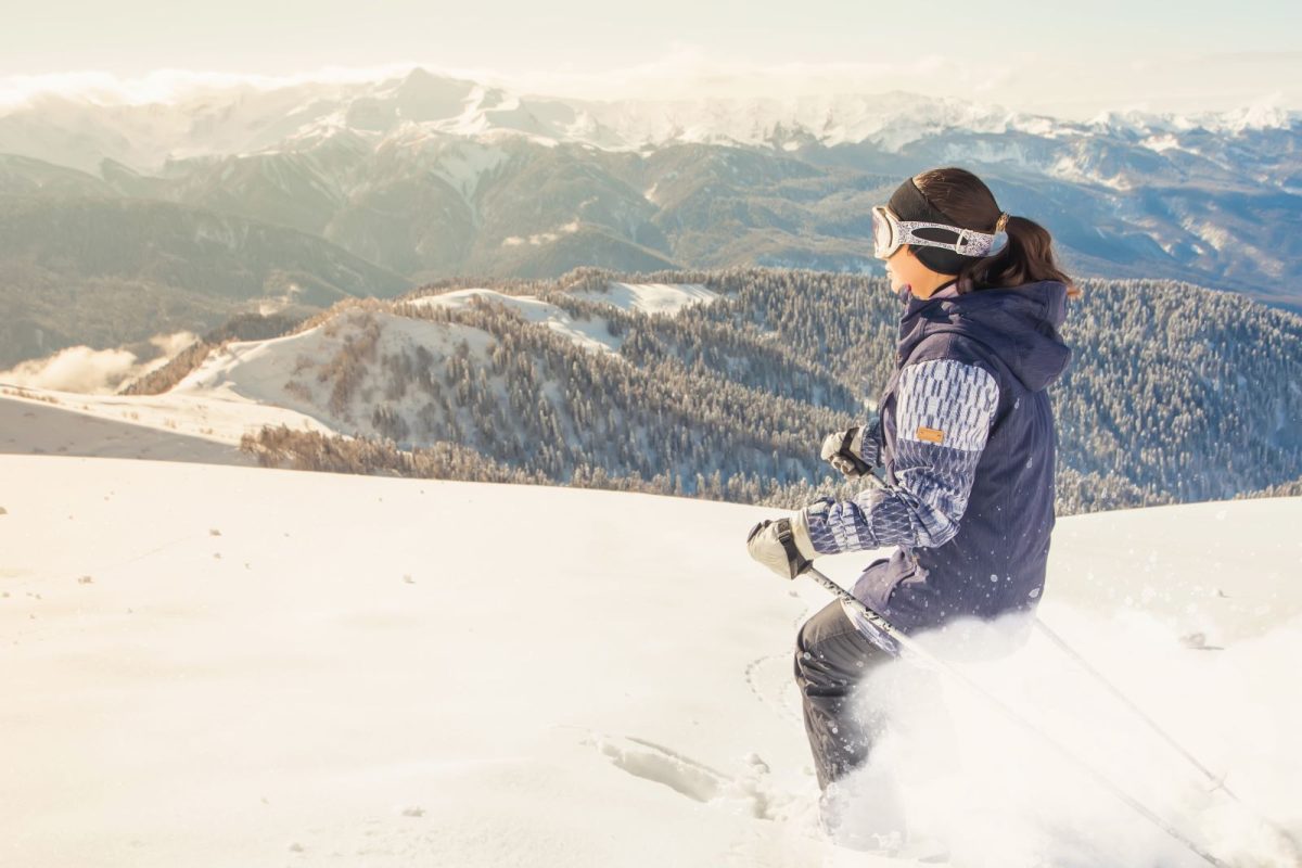 Woman skiing with mountain view.